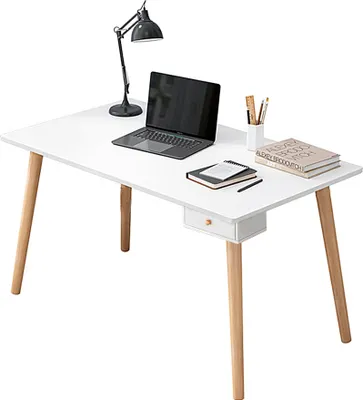 A white desk with a laptop, lamp, books, and a small drawer.