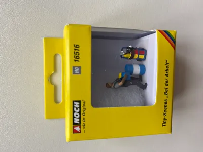 Produktbild von NOCH handkolorierte Tiny-Scenes Bei der Arbeit mit männlichem Lagerarbeiter, Tonne und Sackkarre für H0 Modellbahnfiguren.
