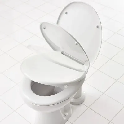 A white toilet with the seat and lid open, shown on a white tiled floor.