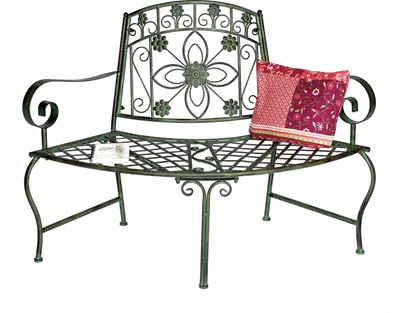 A green metal garden bench with a decorative floral backrest and a patterned cushion on the seat.