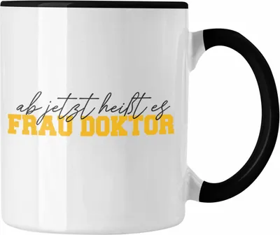 Produktbild von Trendation - Doktortitel Bestanden Tasse Geschenk "Ab Jetzt Heußt Es Frau Doktor" (Schwarz)
