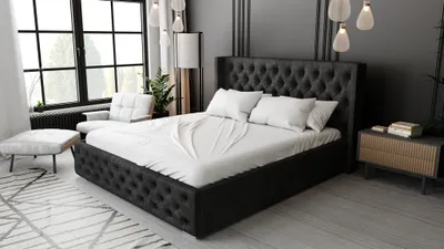 A bedroom scene featuring a large, upholstered bed.