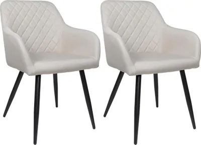 Two beige upholstered dining chairs with black legs are shown against a white background.