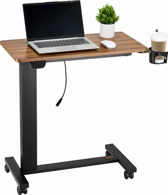 A mobile, height-adjustable laptop table with a wooden top, black metal base, and wheels. It includes a laptop, mouse, plant, and a cup holder with a drink.