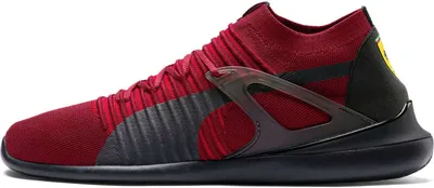 A side view of a red and black Puma Scuderia Ferrari sneaker.