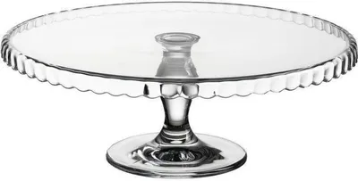 A clear glass cake stand with a fluted edge and a pedestal base.
