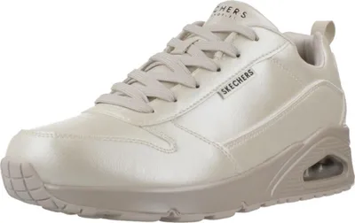 A studio shot of a single beige Skechers sneaker against a white background.