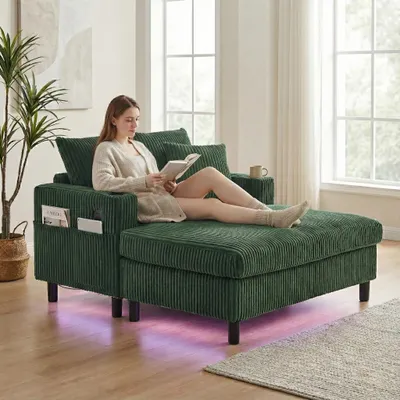 A woman is reading a book while sitting on a green sofa with LED lights underneath.