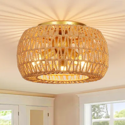 A close-up view of a woven rattan ceiling light fixture with a gold-colored base, mounted on a white ceiling.