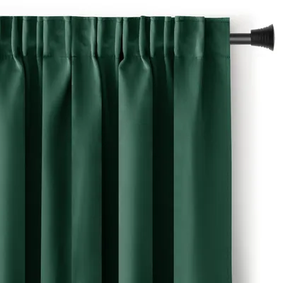 A close-up view of a dark green curtain hanging from a curtain rod.