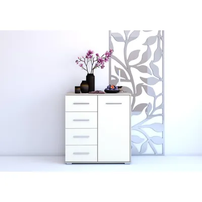 A white dresser with drawers and a cabinet door, decorated with a vase of flowers and a bowl of fruit, stands against a white wall next to a decorative screen.