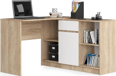 A corner desk with a laptop, books, and storage compartments.