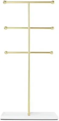 A gold jewelry stand with a white base against a white background.
