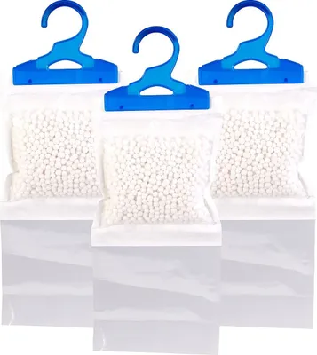 Three hanging dehumidifier bags with blue hangers, filled with white beads, are displayed against a white background.