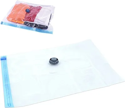 Two vacuum storage bags for clothes, one filled with clothes and the other empty.