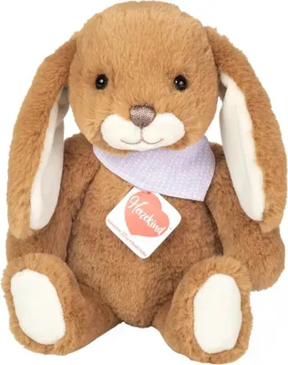 A brown teddy bear bunny with floppy ears and a purple polka dot bandana sits facing the camera.