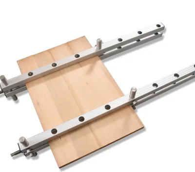 A woodworking clamp holding together pieces of wood.