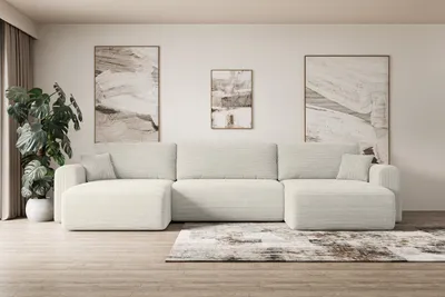 A modern living room with a large sectional sofa, abstract art on the wall, and a potted plant.