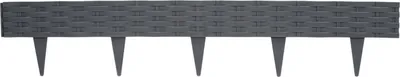 A single piece of dark gray, rattan-style garden edging with stakes.