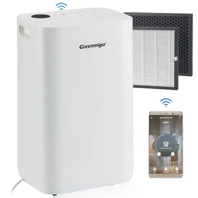A white air purifier is shown with two replacement filters and a smartphone displaying its app interface.