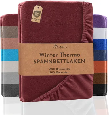 A folded winter thermo fleece fitted sheet is displayed with other sheets of different colors in the background.
