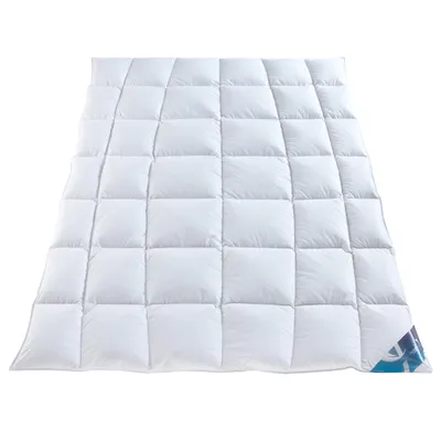 A white duvet or comforter is spread out on a white background.