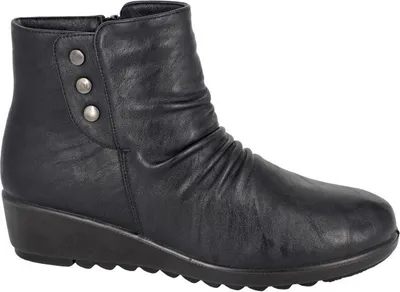 A black leather ankle boot with a wedge heel and decorative buttons on the side.