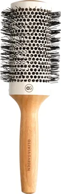 A professional studio shot of a round hairbrush with a wooden handle and white barrel.