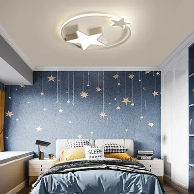 A bedroom with a star-themed wallpaper and a star-shaped ceiling light.