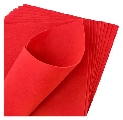 A stack of red felt sheets, with one sheet curled to show its texture.