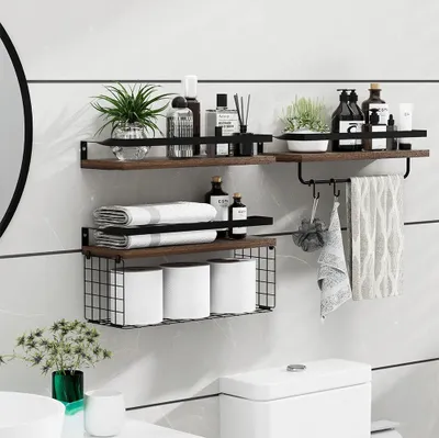 A bathroom shelf unit with toiletries, towels, and toilet paper.