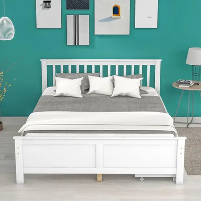 A white bed with bedding in a room with teal walls and artwork.
