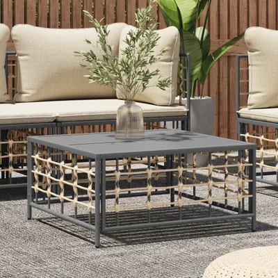An outdoor living space with a coffee table, sofa, and plants.