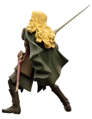 A figurine of a female warrior with blonde hair, wearing a green cape and chainmail armor, holding a sword.