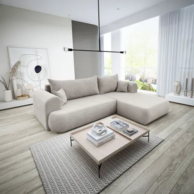 A modern living room with a beige sectional sofa, coffee table, and artwork.
