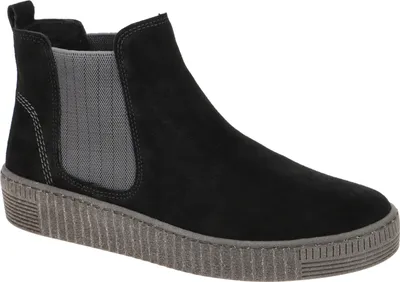 A black Chelsea boot with a gray sole and elastic side panels, shown from a side angle against a white background.