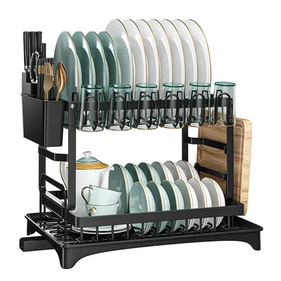 A black, two-tiered dish drying rack filled with dishes, cups, and cutlery. A wooden cutting board is attached to the side.