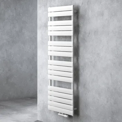 A white radiator is mounted on a textured gray wall.