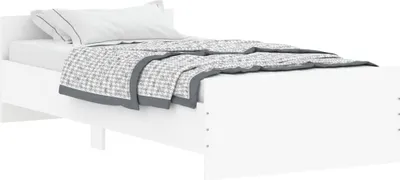A white bed frame with white bedding and a gray and white patterned blanket is shown from a side angle against a white background.