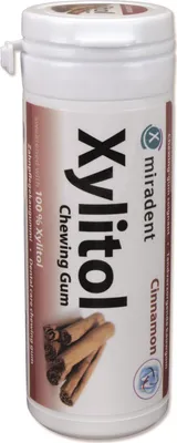 A white cylindrical container of chewing gum with cinnamon sticks depicted on it.