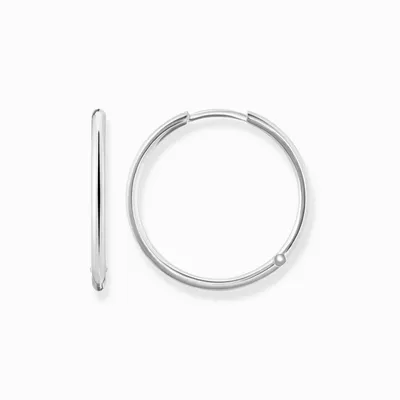 Two silver hoop earrings on a white background.