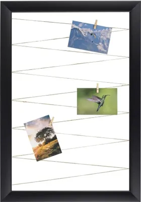 A black framed photo collage board with three photos clipped to strings.