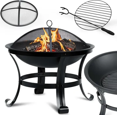 A black metal fire pit with a mesh cover and burning logs inside, along with a grilling grate and a separate fire pit bowl.