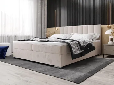 A modern bedroom with a large upholstered bed.