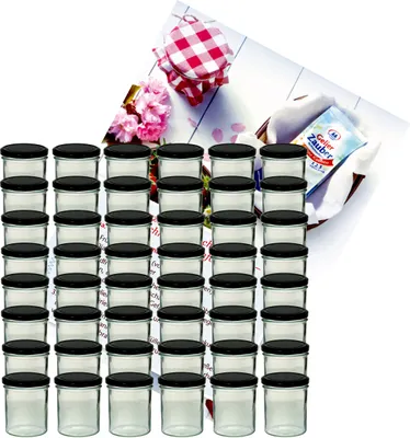 A set of glass jars with black lids, arranged in rows, with a decorative background featuring a checkered cloth, flowers, and a product package.