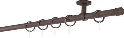 A curtain rod with rings attached, mounted to a ceiling.
