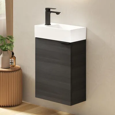 A wall-mounted bathroom vanity with a ceramic sink and a black faucet.