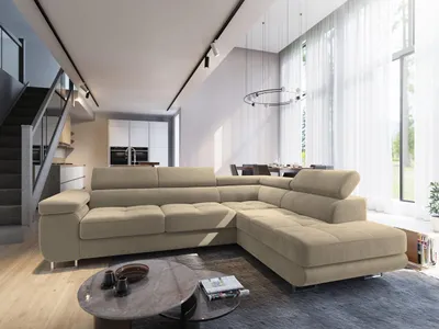 A modern living room with a large sectional sofa, dining area, and staircase.
