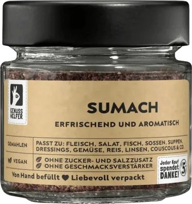 A jar of ground sumac spice with a label.