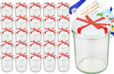 A set of glass jars with red ribbon decoration on their lids, along with recipe booklets.